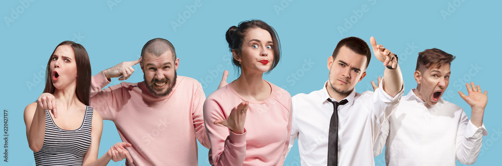 Argue, arguing concept. Beautiful male and female half-length portrait isolated on blue studio backgroud. Young emotional surprised men and woman looking at camera. Human emotions, facial expression Argue, arguing concept. Beautiful male and female half-length portrait isolated on blue studio backgroud. Young emotional surprised men and woman looking at camera. Human emotions, facial expression
