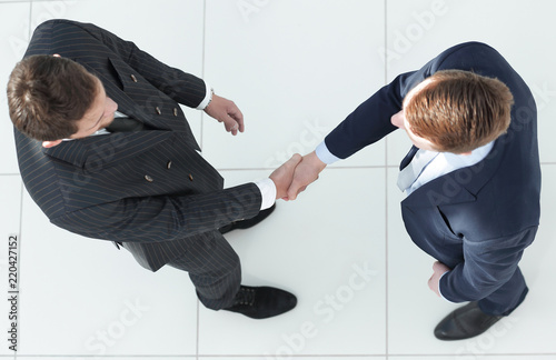 view from the top.handshake, business partners ,isolated on white background.