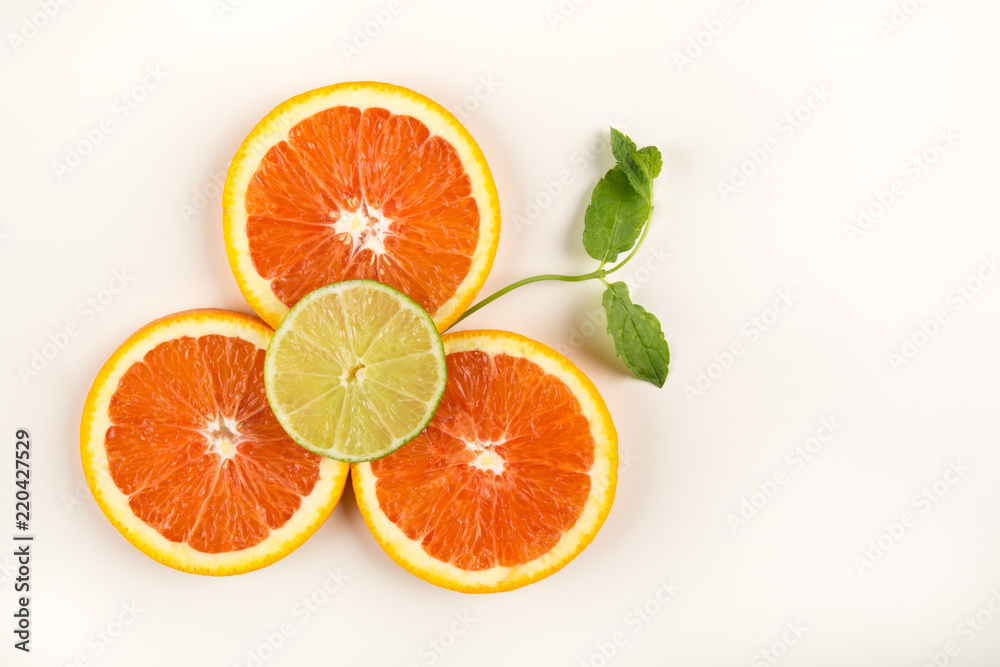 Citrus flower made of citrus fruits, blood orange, lime and mint. Food art creative concepts. isolated on white background. copy space Citrus flower made of citrus fruits, blood orange, lime and mint. Food art creative concepts. isolated on white background. copy space