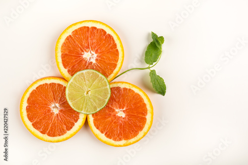 Citrus flower made of citrus fruits, blood orange, lime and mint. Food art creative concepts. isolated on white background. copy space