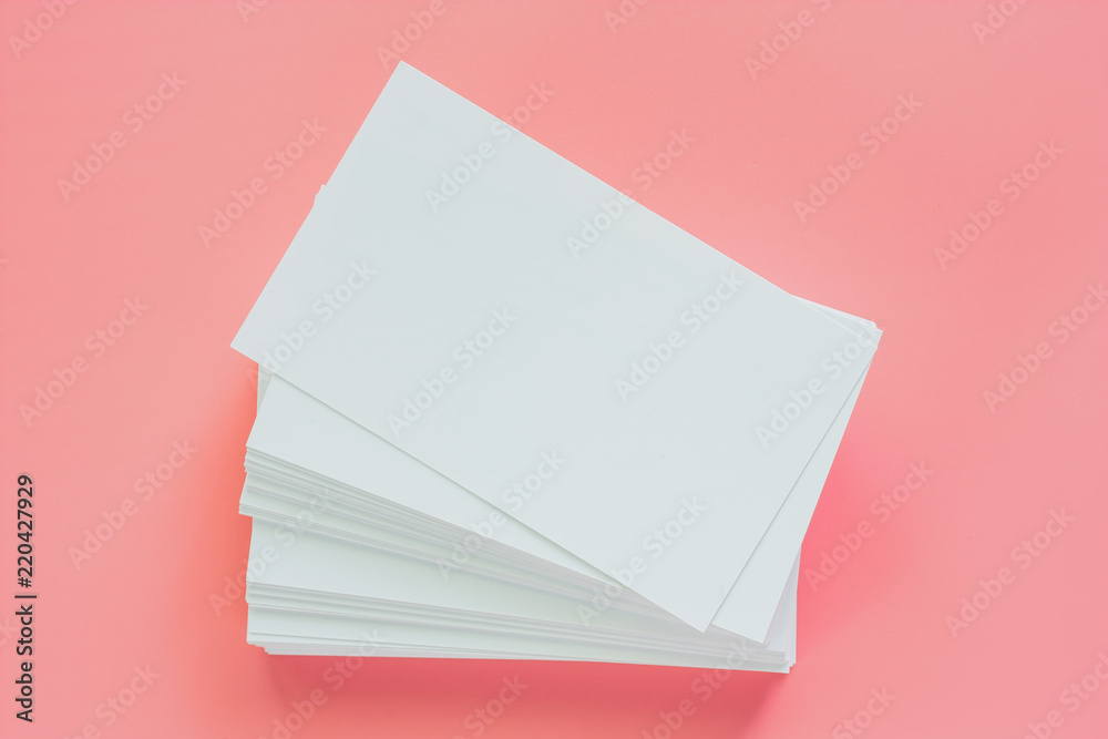 Blank business cards on pink background for contact and communication concept Blank business cards on pink background for contact and communication concept