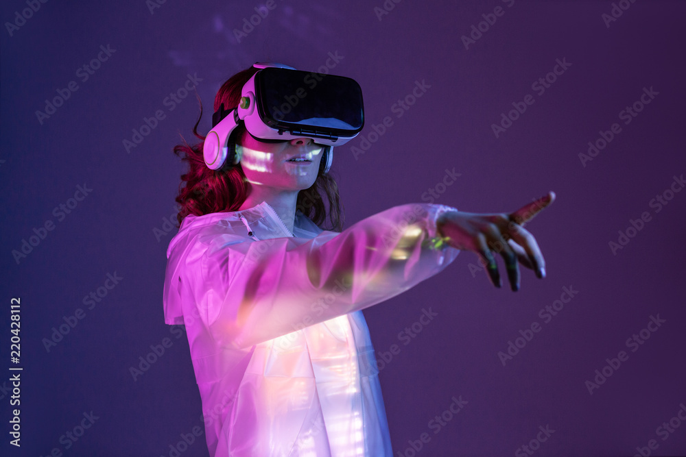 Woman touching air in VR glasses Woman touching air in VR glasses