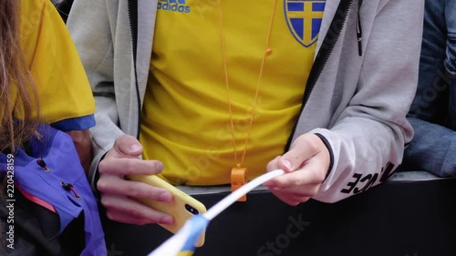 Guy from Sweden waving the Swedish flag and filming with a yellow phone at the KMD Ironman Copenhagen 2018 photo