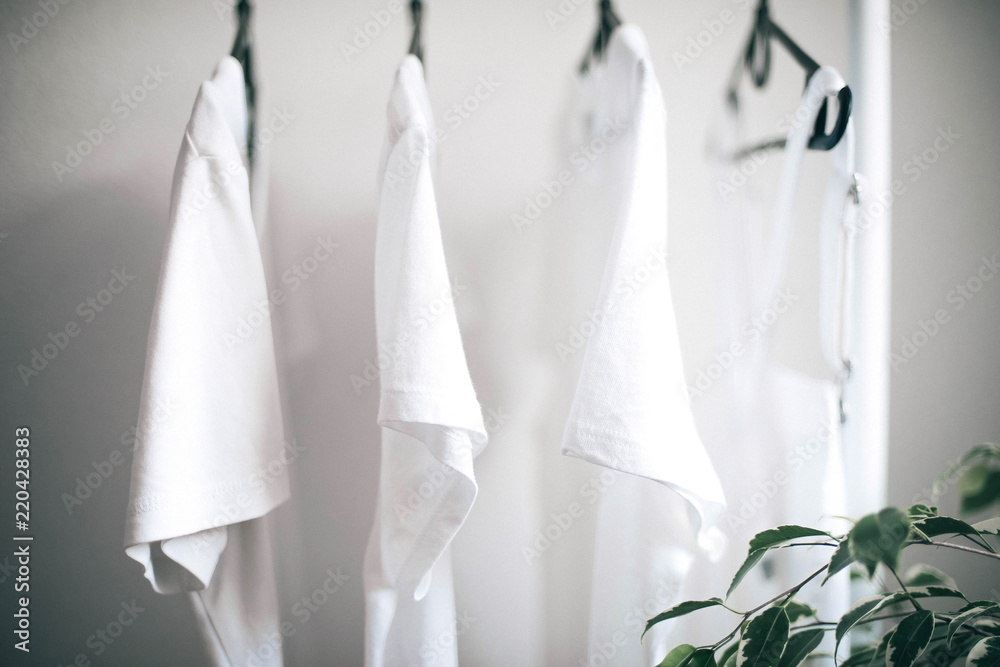 Interior Design. white clothes hanging on a hanger Interior Design. white clothes hanging on a hanger