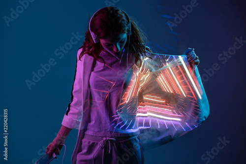 Woman in headphones with projected light on jacket photo