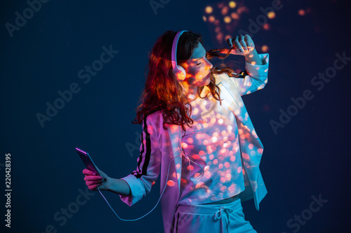 Woman enjoying music with mobile phone photo