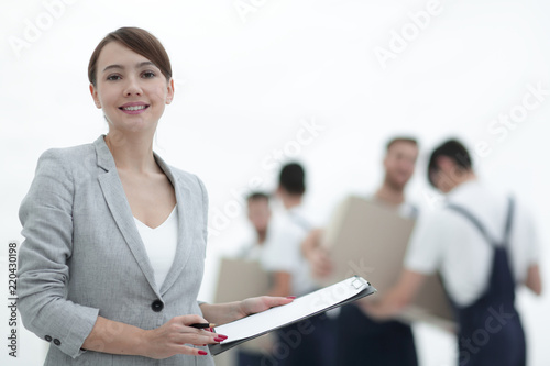 Woman manager holding clipboard on blurred background with mover