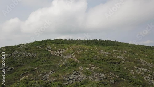 Aerial footage of White Cap Mountain situated within the watershed of the Pleasant River located in Piscataquis County, Maine. It has a distinguished treeline and remains snow covered into summer. photo