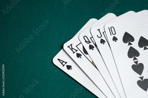 Royal flush combination cards on green table for Poker game