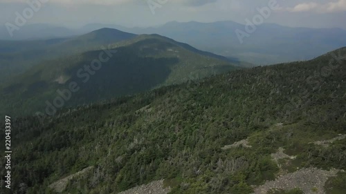Aerial footage of White Cap Mountain situated within the watershed of the Pleasant River located in Piscataquis County, Maine. It has a distinguished treeline and remains snow covered into summer. photo