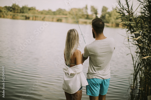Lovely young couple fishing...