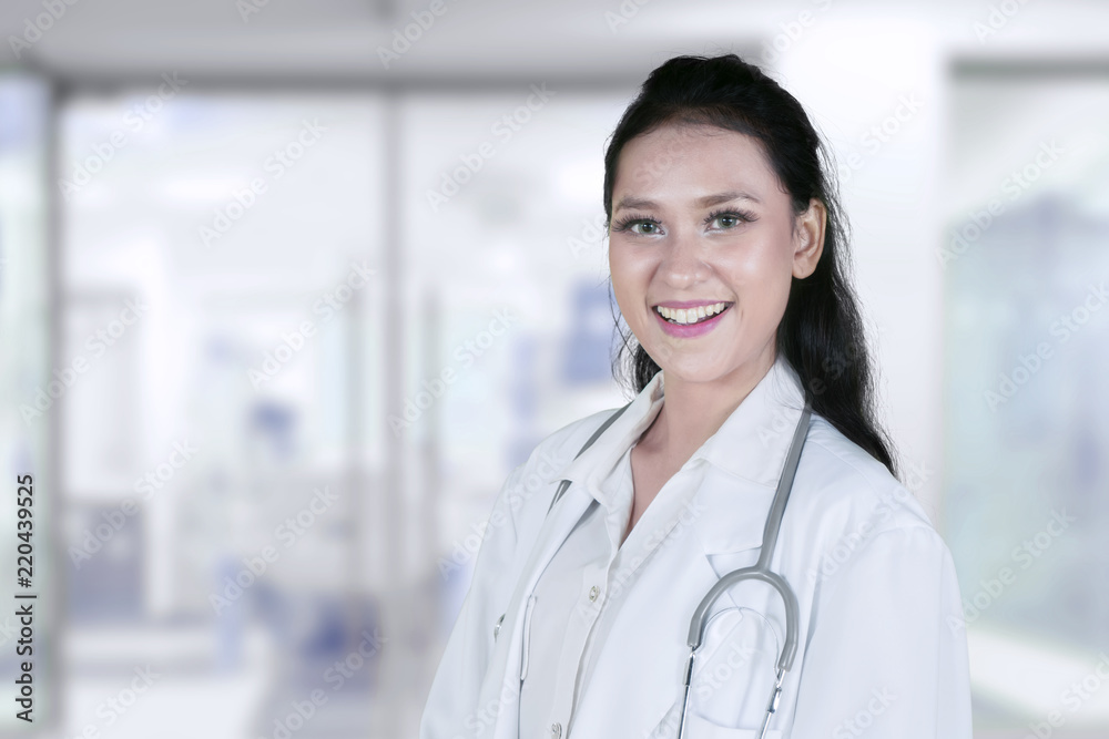 Friendly female doctor standing in the clinic Friendly female doctor standing in the clinic