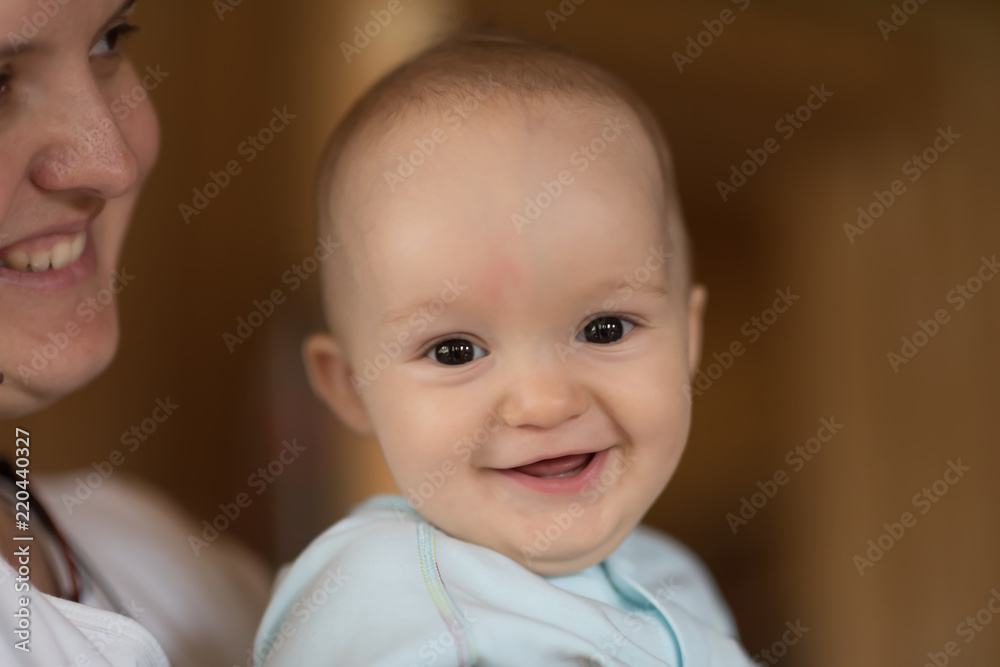 Portrait of a beautiful little baby with his mother. Close-up Portrait of a beautiful little baby with his mother. Close-up