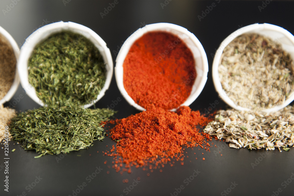 Close up various spices on black background: rosemary, paprika, black pepper. Close up various spices on black background: rosemary, paprika, black pepper.
