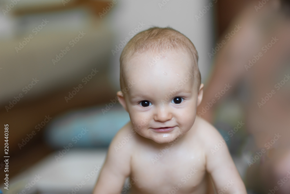 baby boy indoor bathing in the small white bathtub . He is smiling and full of happiness baby boy indoor bathing in the small white bathtub . He is smiling and full of happiness