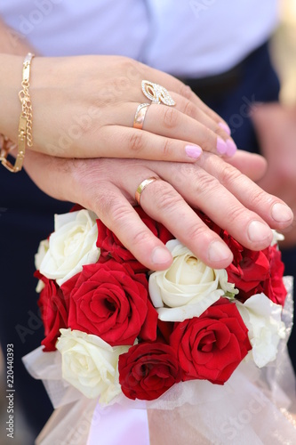 hands of husband and wife with wedding rings.  