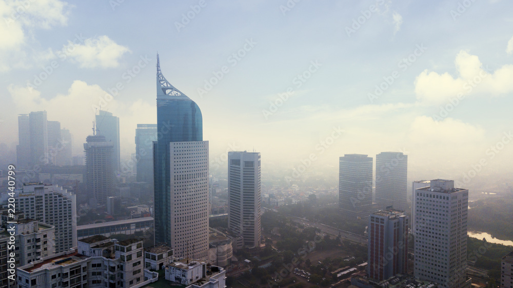 Jakarta cityscape with skyscraper in misty morning