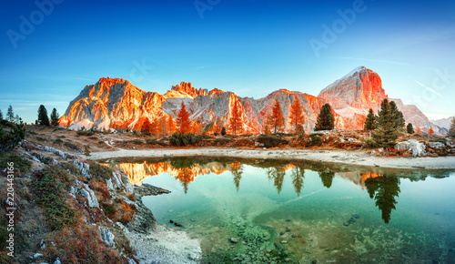 Mountain lake Limides in Italy, located in south Tyrol in high Dolomite Alpine mountains. Blue, red and turquoise colors in nature. Gorgeous landscape photography, panoramic view. Sunrise scenery. photo