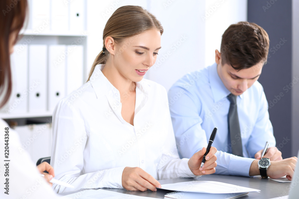 Group of business people or lawyers discussing terms of transaction in office. Meeting and teamwork concept Group of business people or lawyers discussing terms of transaction in office. Meeting and teamwork concept