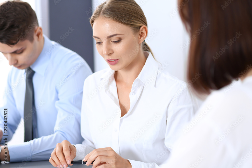 Fototapeta premium Group of business people or lawyers discussing terms of transaction in office. Meeting and teamwork concept