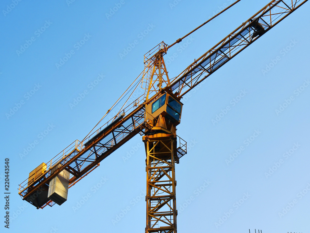 Construction crane against blue sky. Construction site Construction crane against blue sky. Construction site