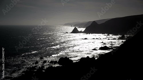 Jagged black hills and silver seas wide