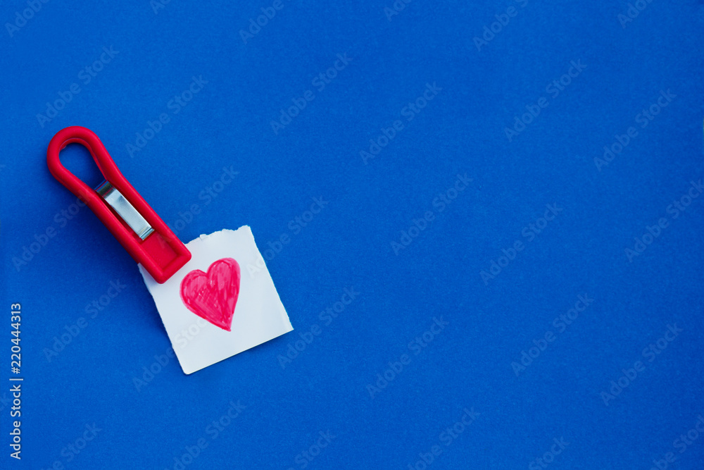 Clothes peg holds a piece of paper Clothes peg holds a piece of paper