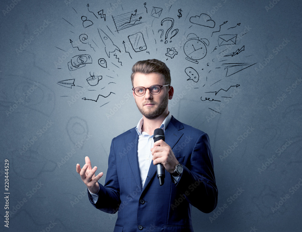 Businessman speaking into microphone with mixed doodles over his head Businessman speaking into microphone with mixed doodles over his head