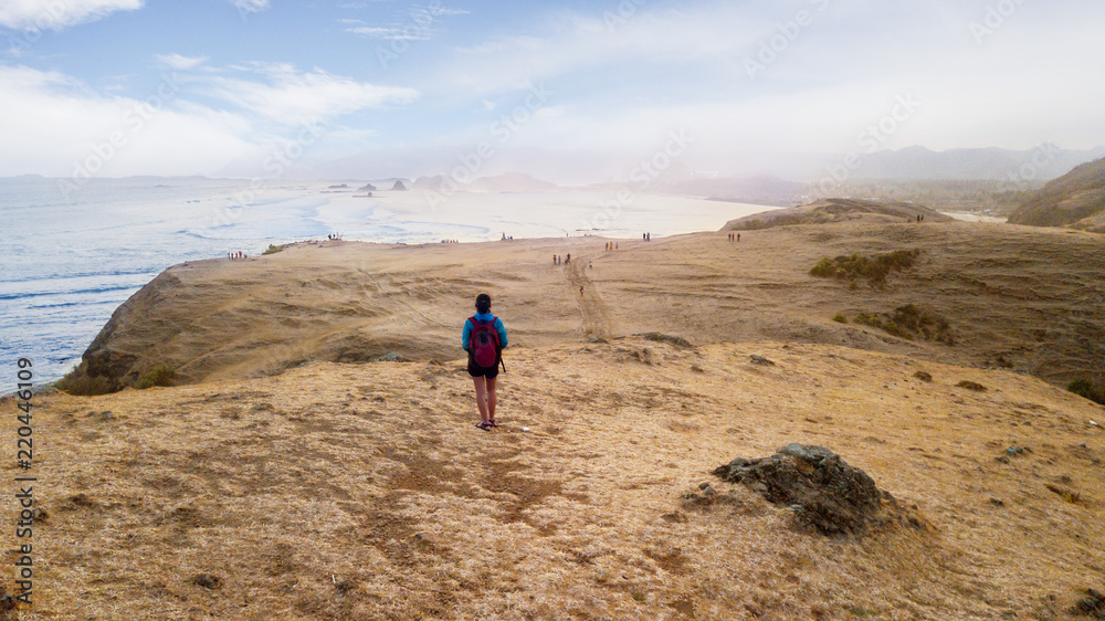 Fototapeta premium Young woman walking on Merese hill