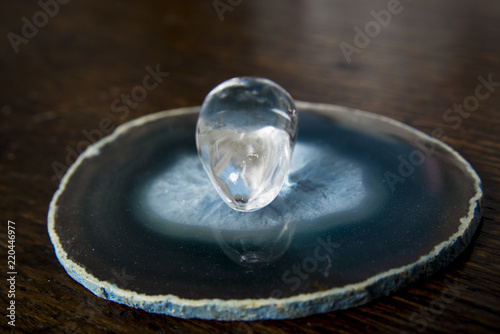 A rock crystal on a disc of agate photo