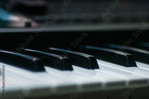 Closeup view of keyboard synthesizer keys and buttons.