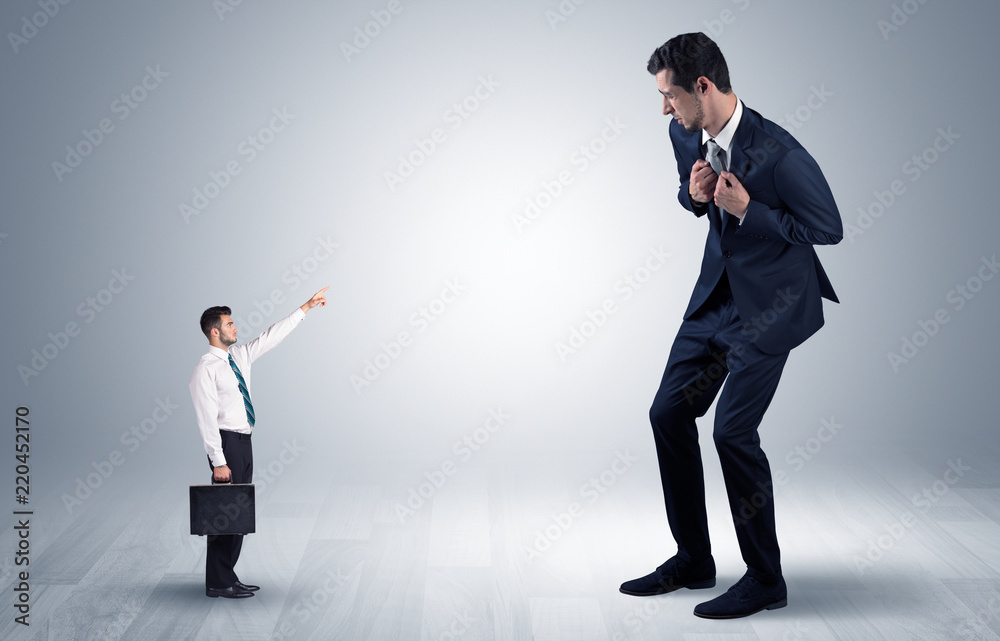 Small businessman in shirt pointing to an afraid businessman
Small businessman in shirt pointing to an afraid businessman