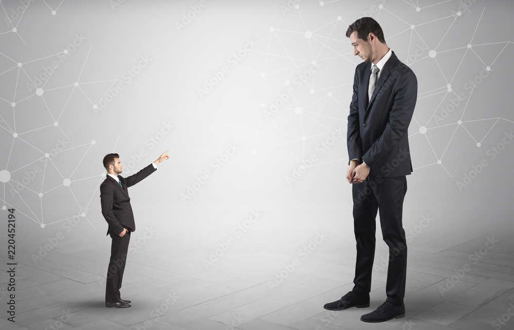 Obraz premium Small businessman aiming at a big businessman with connection and network concept 