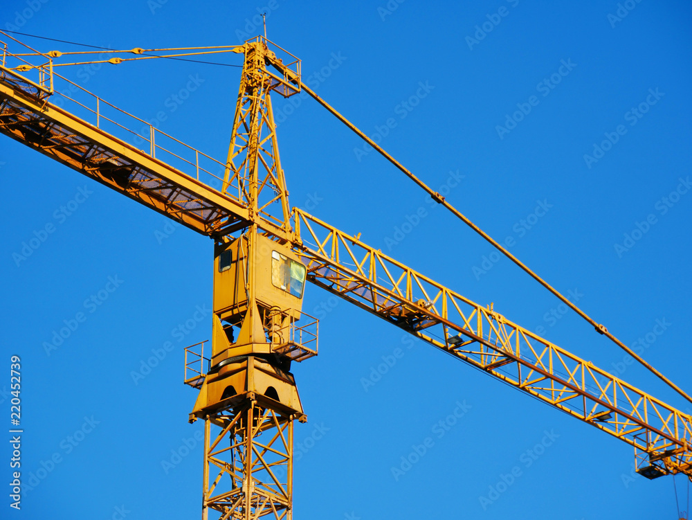 Crane. Construction crane against blue sky. Crane. Construction crane against blue sky.