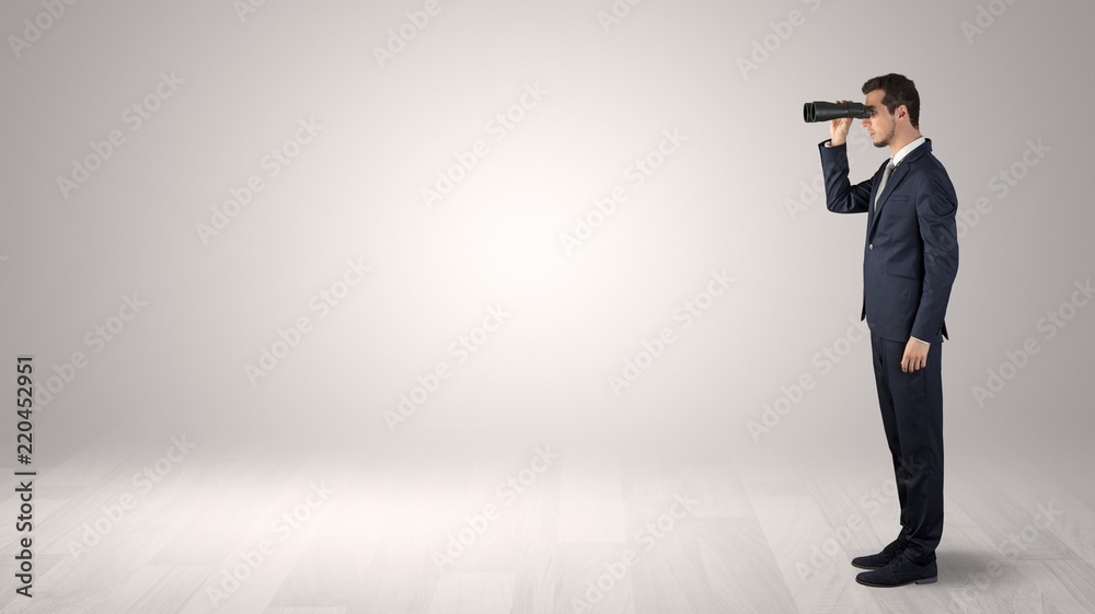 Businessman looking forward with binoculars in an empty space
Businessman looking forward with binoculars in an empty space