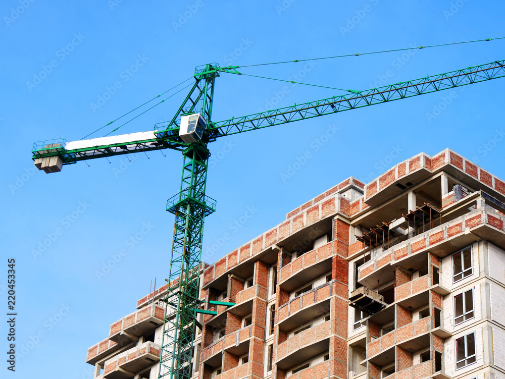 Building site. Huge crane near building. Building site. Huge crane near building.