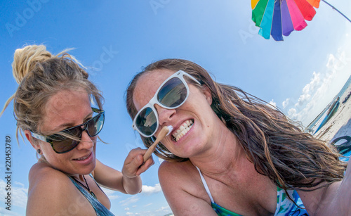 LOVERS KEY, FORT MYERS BEACH, FLOIRDA/USA 11/4/15: Female brushing her girlfriends teeth at the beach.