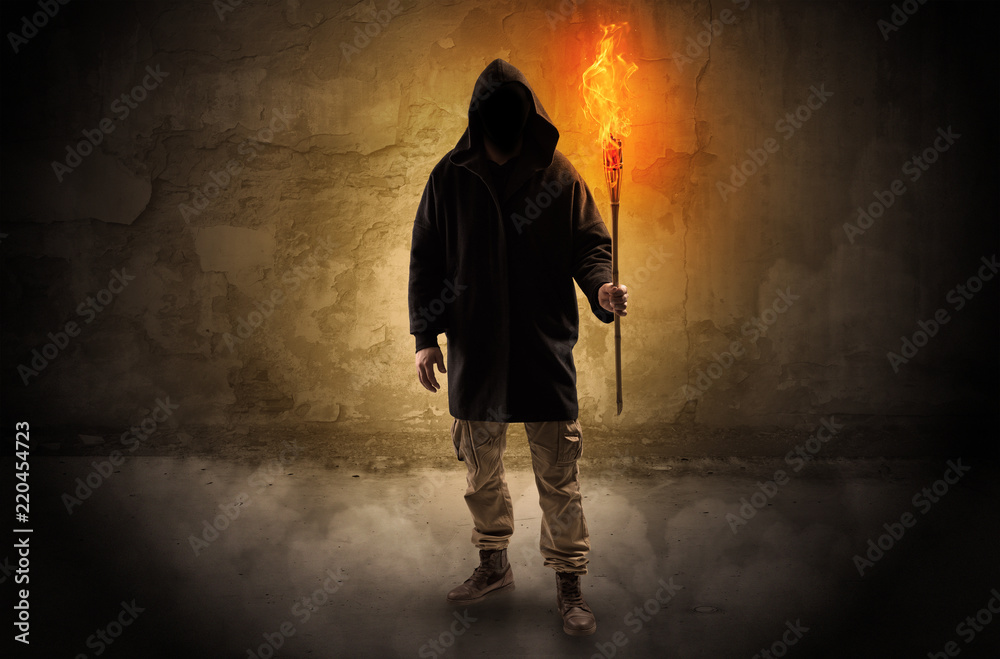 Ugly wayfarer with burning torch in his hand in front of a crumbly wall concept
Ugly wayfarer with burning torch in his hand in front of a crumbly wall concept