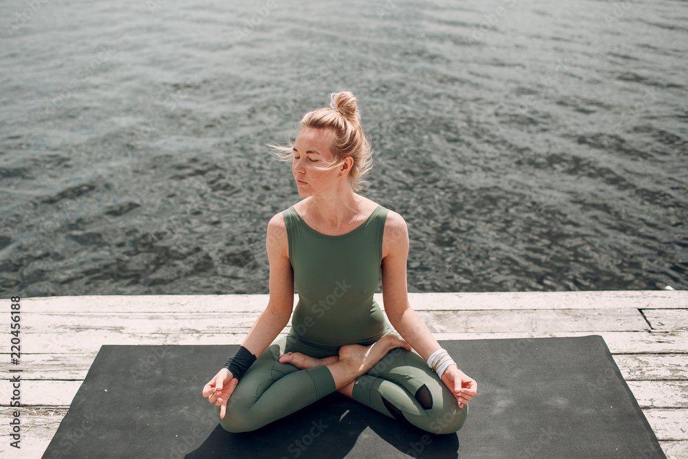Fototapeta premium Young woman doing yoga practice