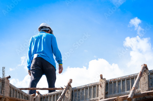 Construction building workers at construction,Man Working at height with blue sky at construction site