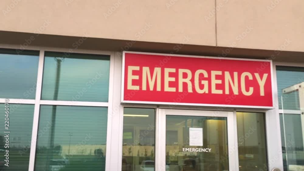 Panning shot of an emergency sign outside of a hospital. Panning shot of an emergency sign outside of a hospital.