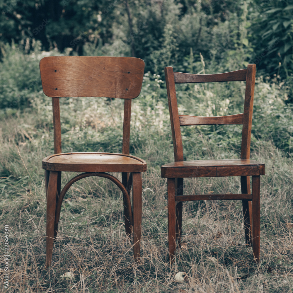 Wooden chair, wooden chair twin, Pair old wooden chair outdoors. Around the lush grass, The environment offers privacy. Wooden chair, wooden chair twin, Pair old wooden chair outdoors. Around the lush grass, The environment offers privacy.