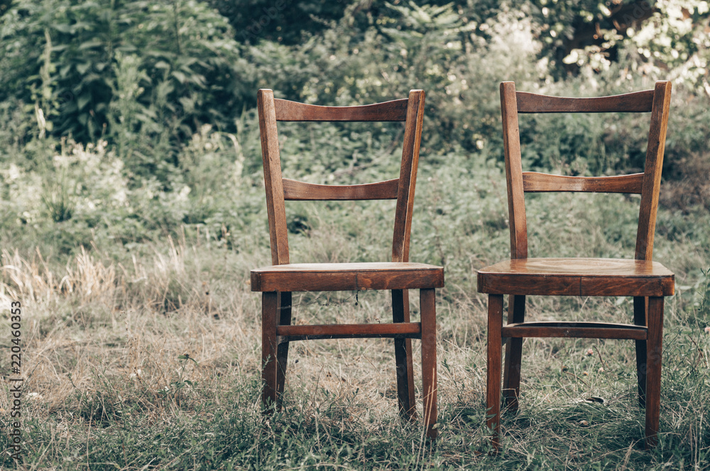 Wooden chair, wooden chair twin, Pair old wooden chair outdoors. Around the lush grass, The environment offers privacy.