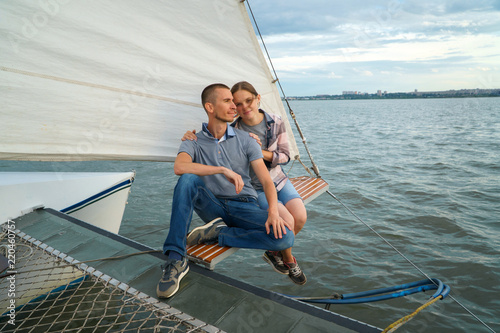 Young Couple hugging, sitting on boat enjoying summer day © SergeyCash