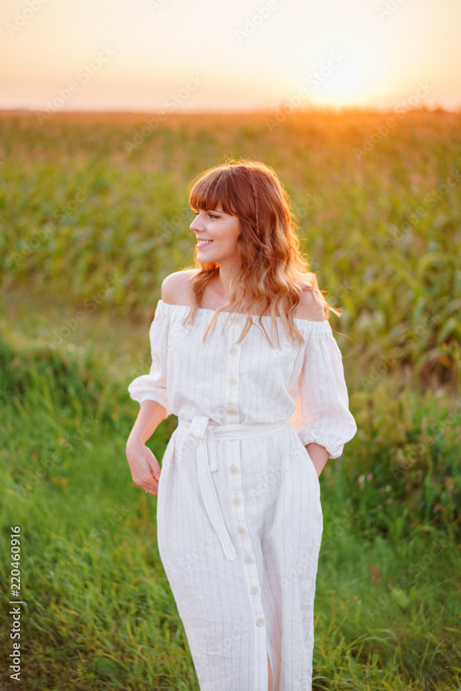 Girl in white dress . Woman in cornfield, place for text. Spike and girl in field. Late summer and early autumn. August or September Girl in white dress . Woman in cornfield, place for text. Spike and girl in field. Late summer and early autumn. August or September