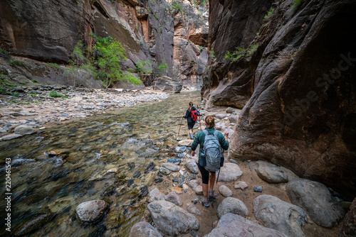 Two Young Female Friends Hiking Through the Narrows, Zion National Park, Utah - USA