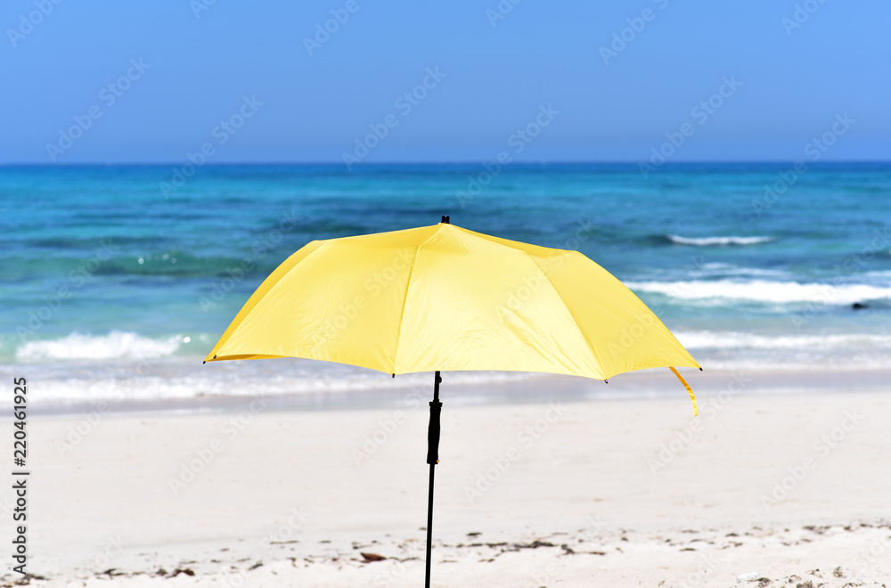 Yellow sun umbrella in Corralejo Beach, Fuerteventura Island, Canary Islands, Spain