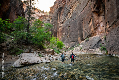 Two Young Female Friends Hiking Through the Narrows, Zion National Park, Utah - USA