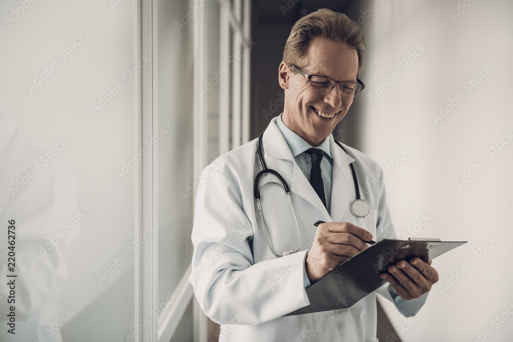 Portrait of Doctor Filling up Medical History Portrait of Doctor Filling up Medical History