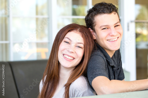Portrait of a brother and sister smiling.